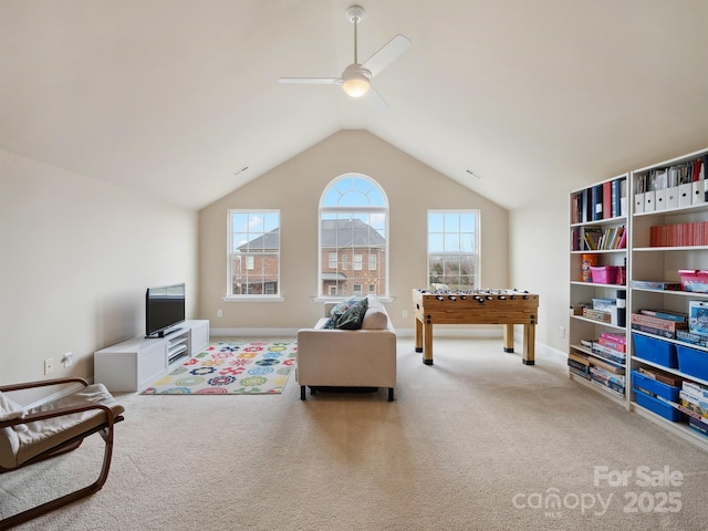 rec room with lofted ceiling, ceiling fan, baseboards, and carpet flooring