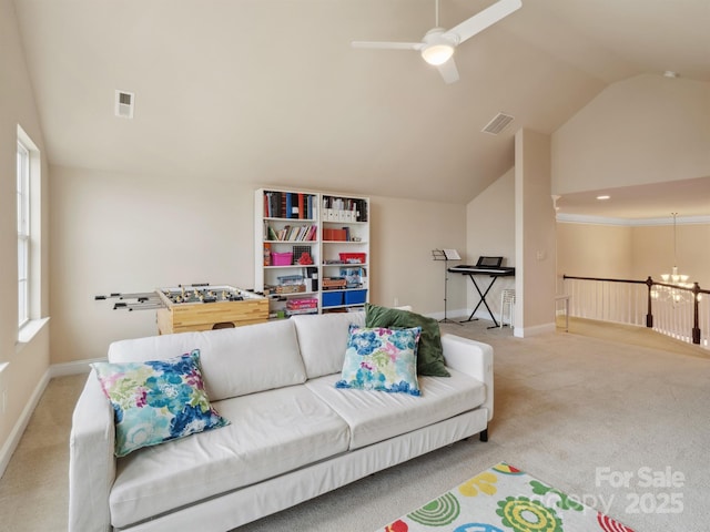 carpeted living room featuring lofted ceiling, ceiling fan with notable chandelier, visible vents, and baseboards