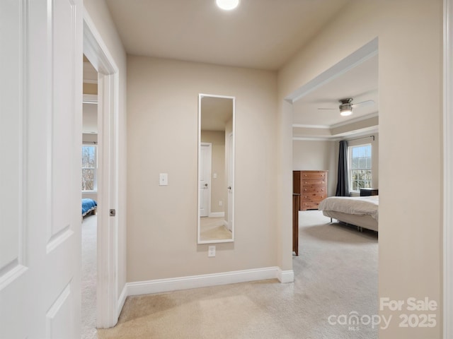 corridor featuring carpet and baseboards