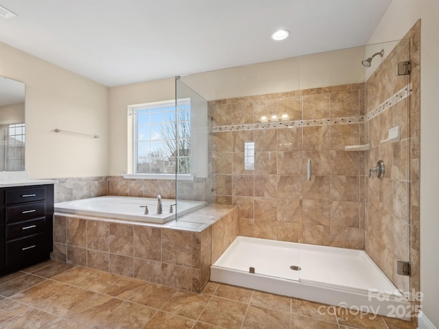 full bath featuring a stall shower, tile patterned flooring, a garden tub, and vanity