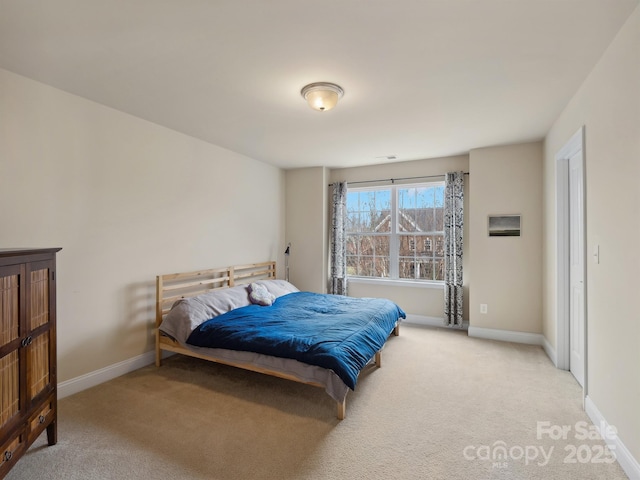 carpeted bedroom featuring baseboards