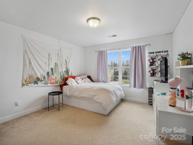 carpeted bedroom featuring visible vents and baseboards