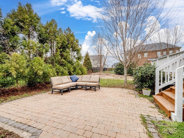 view of patio featuring outdoor lounge area and fence