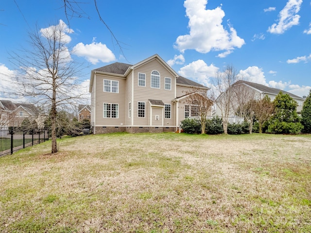 back of property featuring a yard, crawl space, and fence