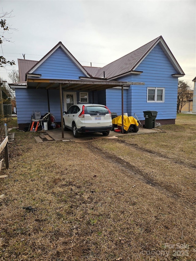 back of property featuring a lawn