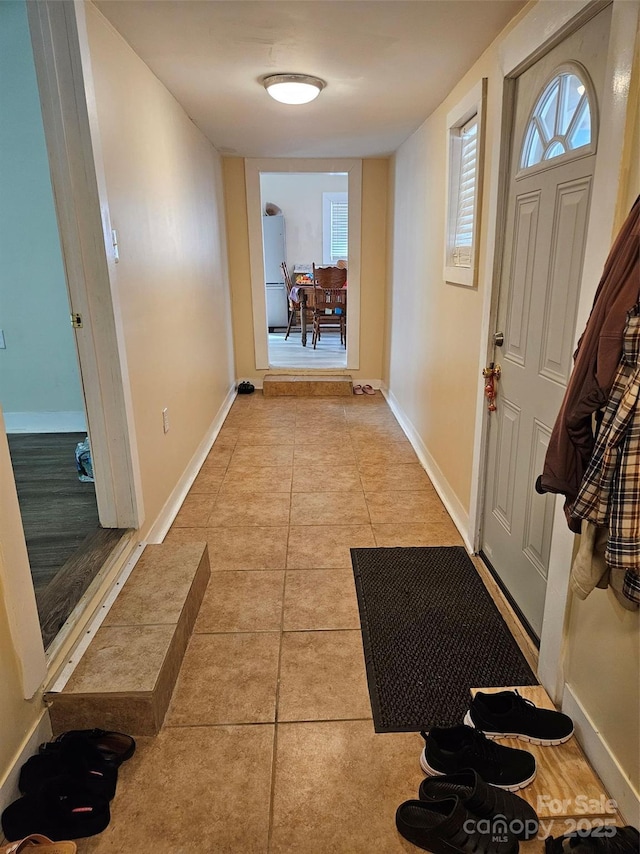 entryway with light tile patterned floors