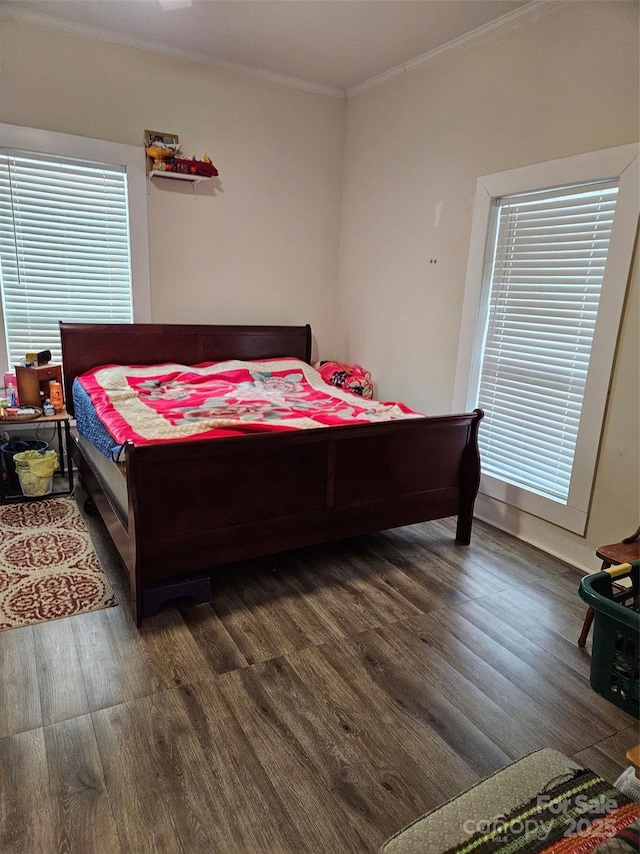 bedroom with dark hardwood / wood-style flooring and crown molding