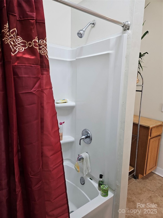 bathroom featuring shower / bath combination with curtain and tile patterned flooring