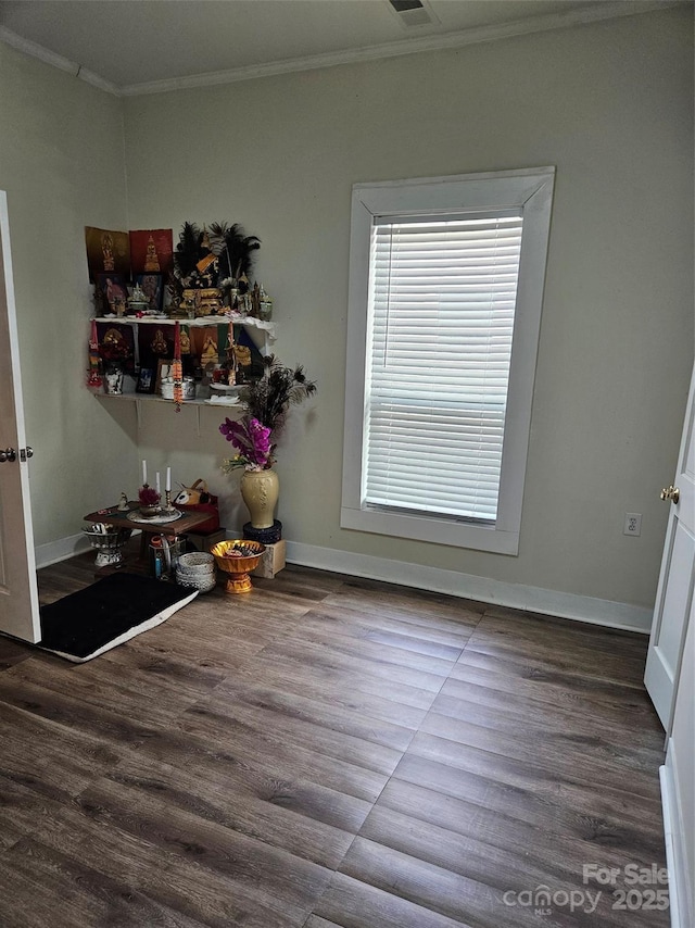 dining area with hardwood / wood-style flooring and crown molding