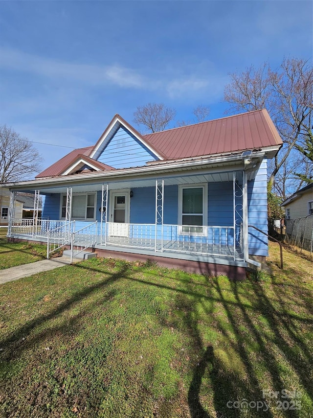 view of front of property with covered porch and a front lawn