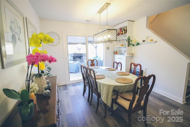 dining space featuring dark wood-type flooring