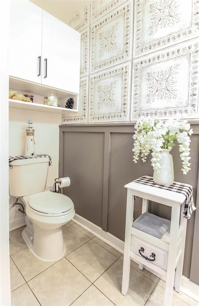 bathroom with toilet and tile patterned floors