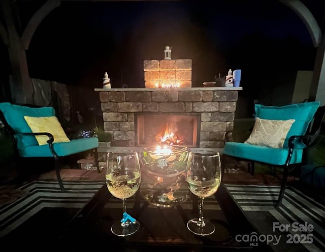 living area with a stone fireplace