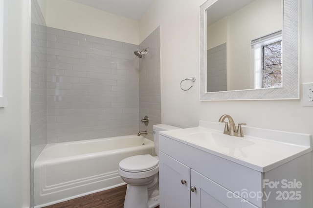 full bathroom featuring toilet, shower / washtub combination, wood finished floors, and vanity