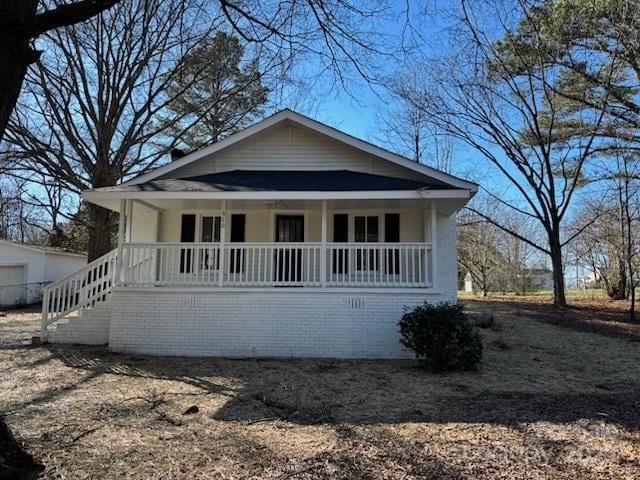 bungalow-style house featuring a porch and stairway