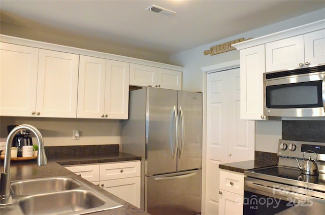 kitchen featuring sink, white cabinetry, and appliances with stainless steel finishes