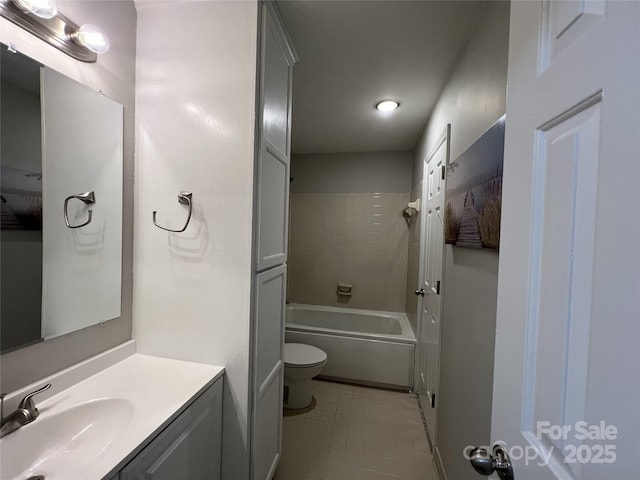 full bathroom featuring tiled shower / bath combo, toilet, and vanity