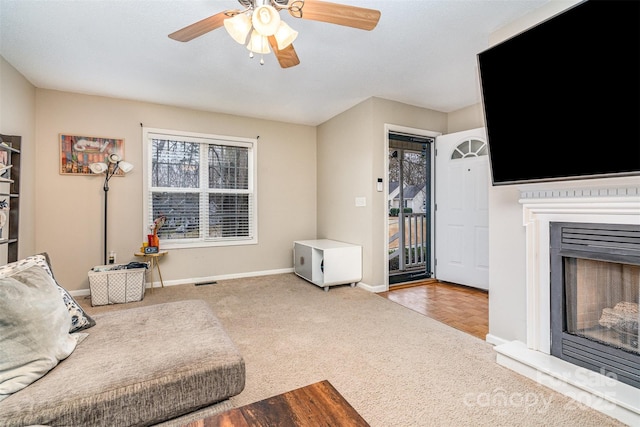 living room featuring ceiling fan and carpet flooring