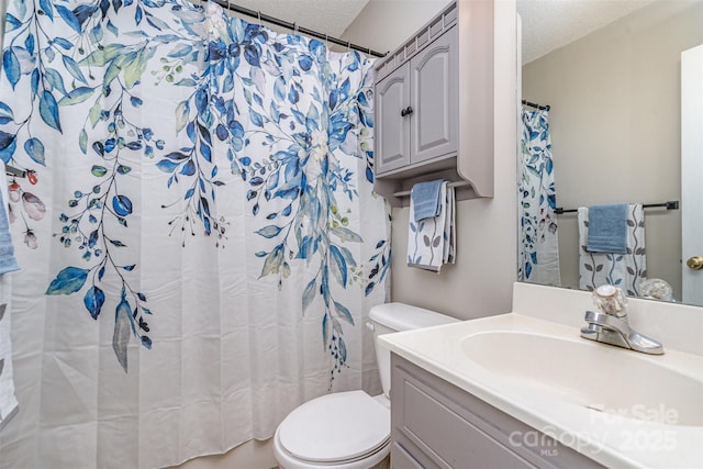 bathroom with vanity, a shower with shower curtain, a textured ceiling, and toilet