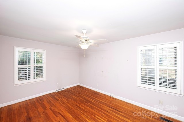 spare room featuring hardwood / wood-style flooring and ceiling fan