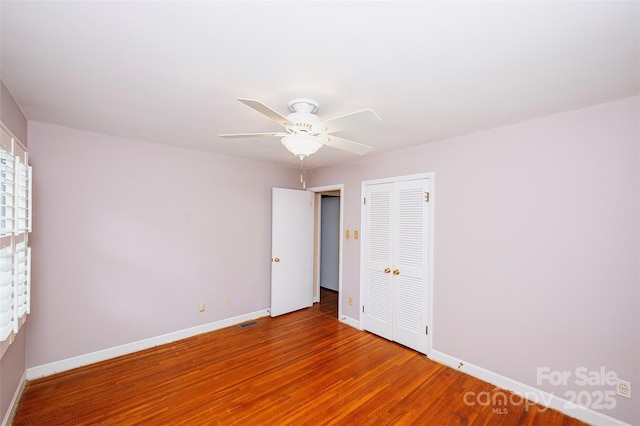 spare room featuring hardwood / wood-style floors and ceiling fan