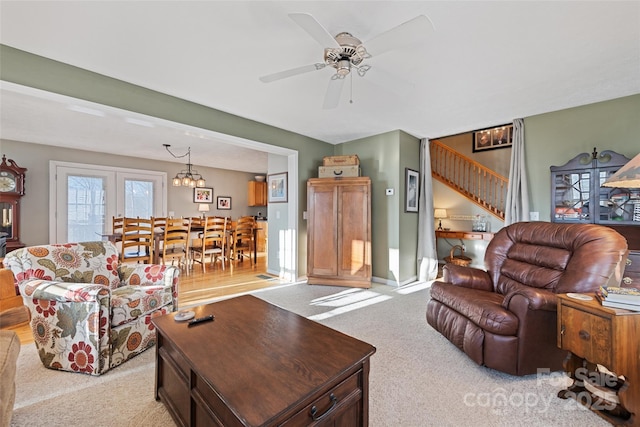 carpeted living room with ceiling fan