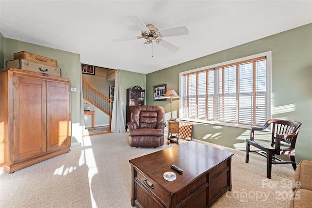 living room featuring ceiling fan and light colored carpet