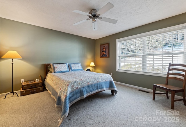 bedroom featuring a textured ceiling, carpet floors, and ceiling fan