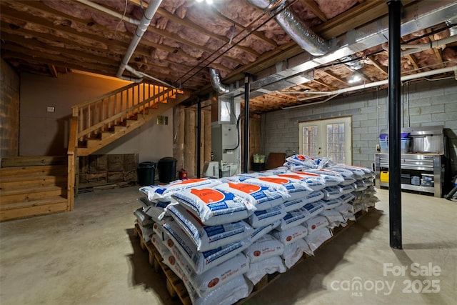 basement with heating unit and french doors