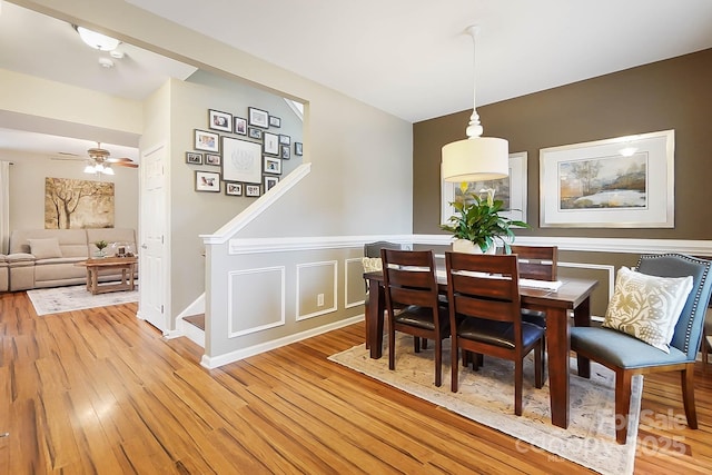 dining area with ceiling fan and light wood-type flooring