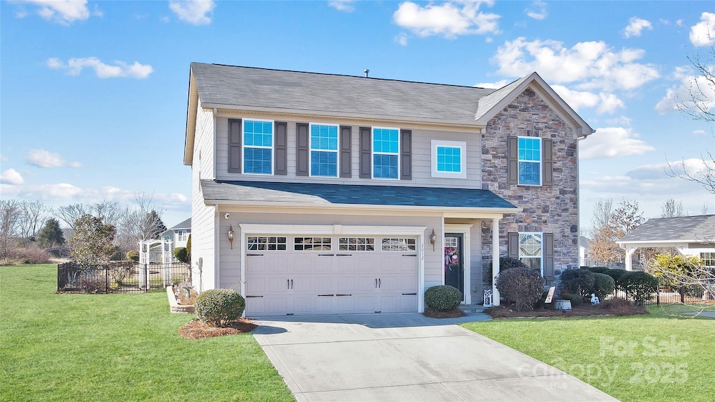 view of front facade with a garage and a front lawn