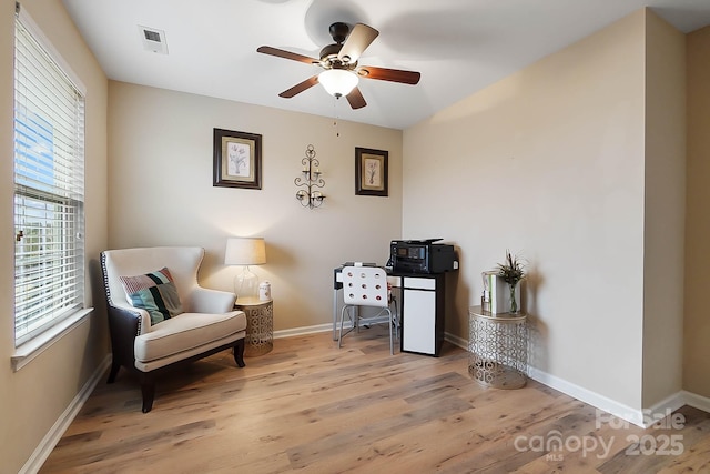 living area with ceiling fan and light wood-type flooring