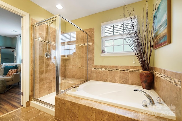 bathroom with tile patterned floors and independent shower and bath