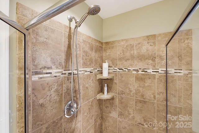 interior details featuring tiled shower