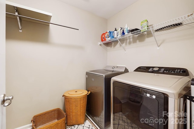 clothes washing area featuring washer and dryer