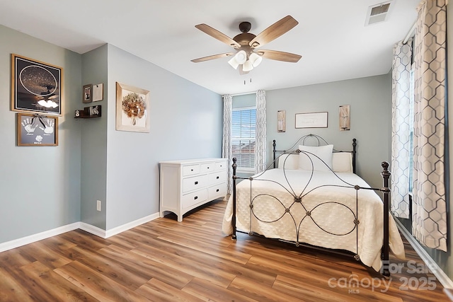 bedroom with ceiling fan and light wood-type flooring