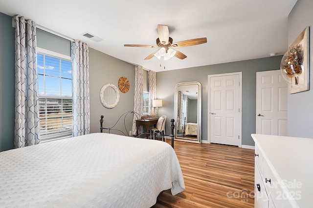 bedroom with hardwood / wood-style flooring and ceiling fan