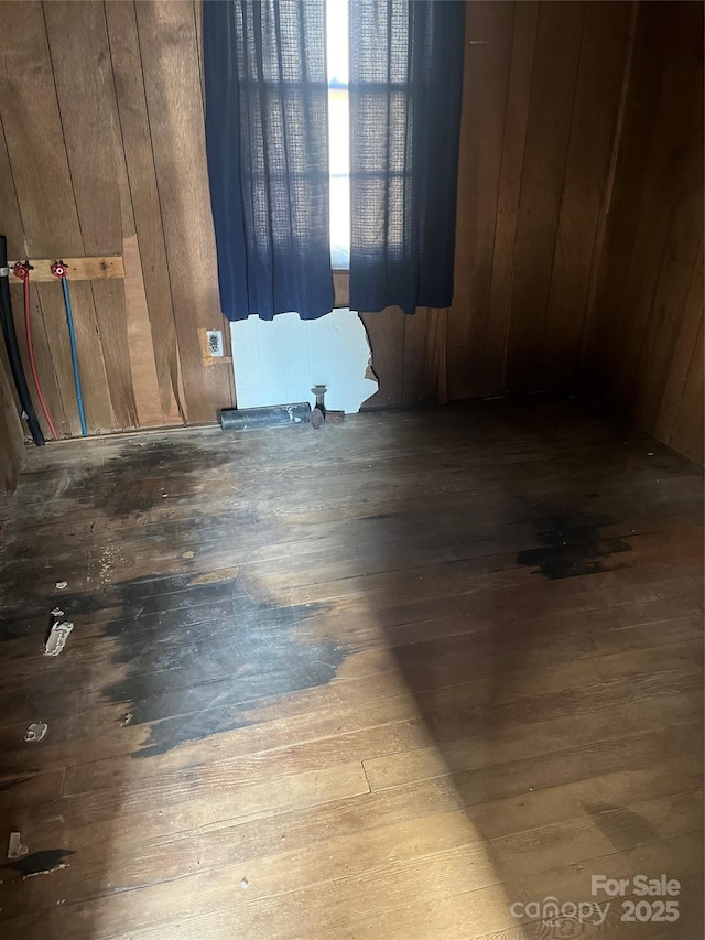 spare room featuring wood-type flooring