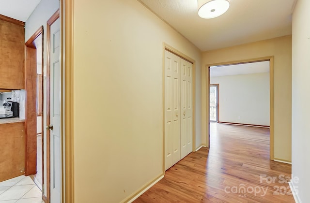 hallway with light hardwood / wood-style flooring