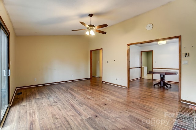 unfurnished bedroom with vaulted ceiling, ceiling fan, and light wood-type flooring