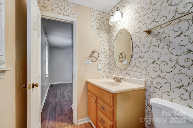 bathroom featuring hardwood / wood-style flooring, vanity, and toilet