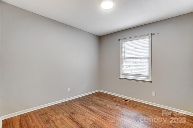 spare room with wood-type flooring