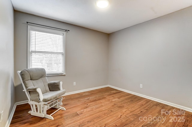 living area with hardwood / wood-style flooring