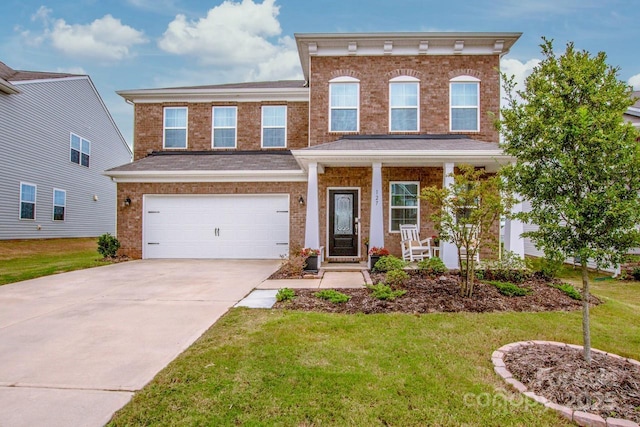 view of front of house with a garage, a front yard, and driveway