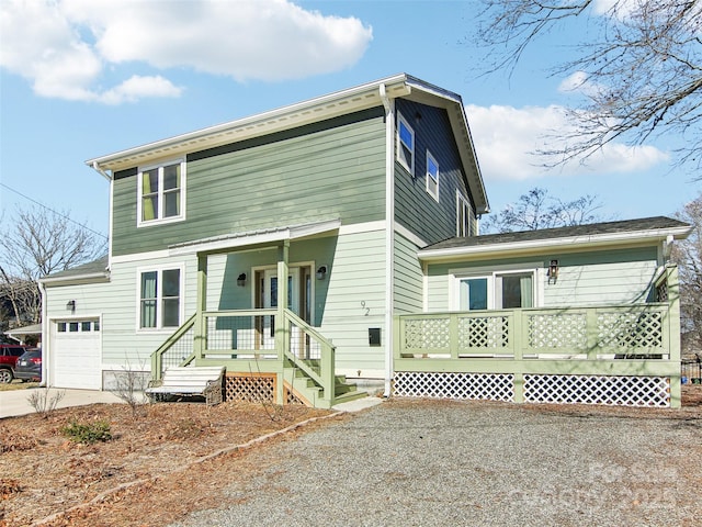 view of front property featuring a porch and a garage