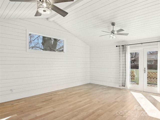 unfurnished sunroom with ceiling fan, lofted ceiling with beams, and french doors