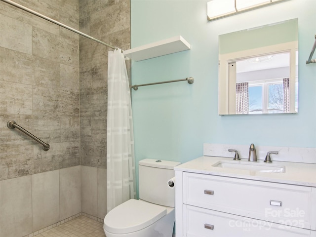 bathroom featuring toilet, vanity, and a shower with curtain