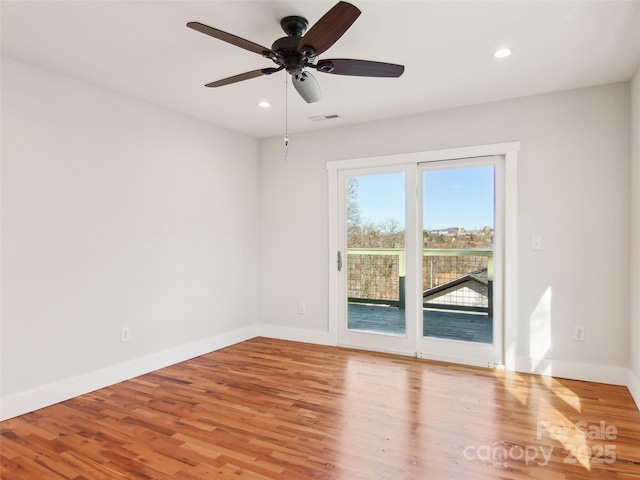 empty room featuring ceiling fan and light hardwood / wood-style floors