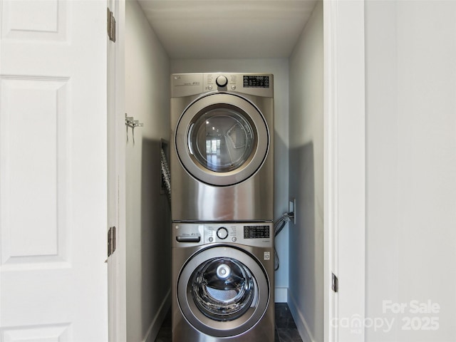 washroom with stacked washing maching and dryer