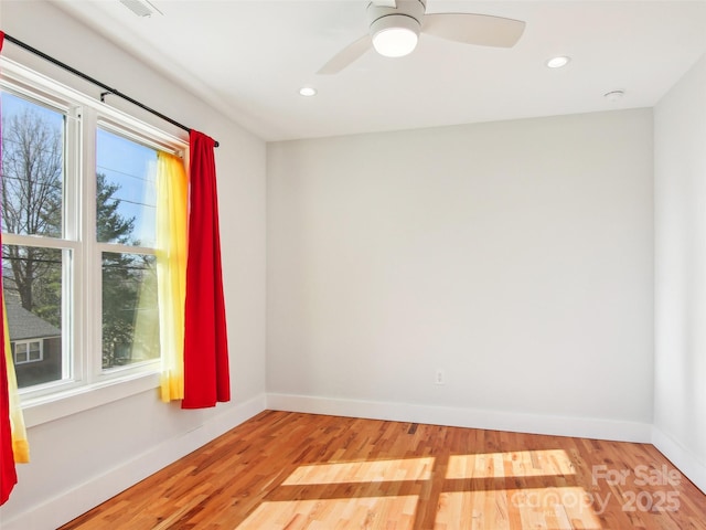 unfurnished room with hardwood / wood-style floors and ceiling fan